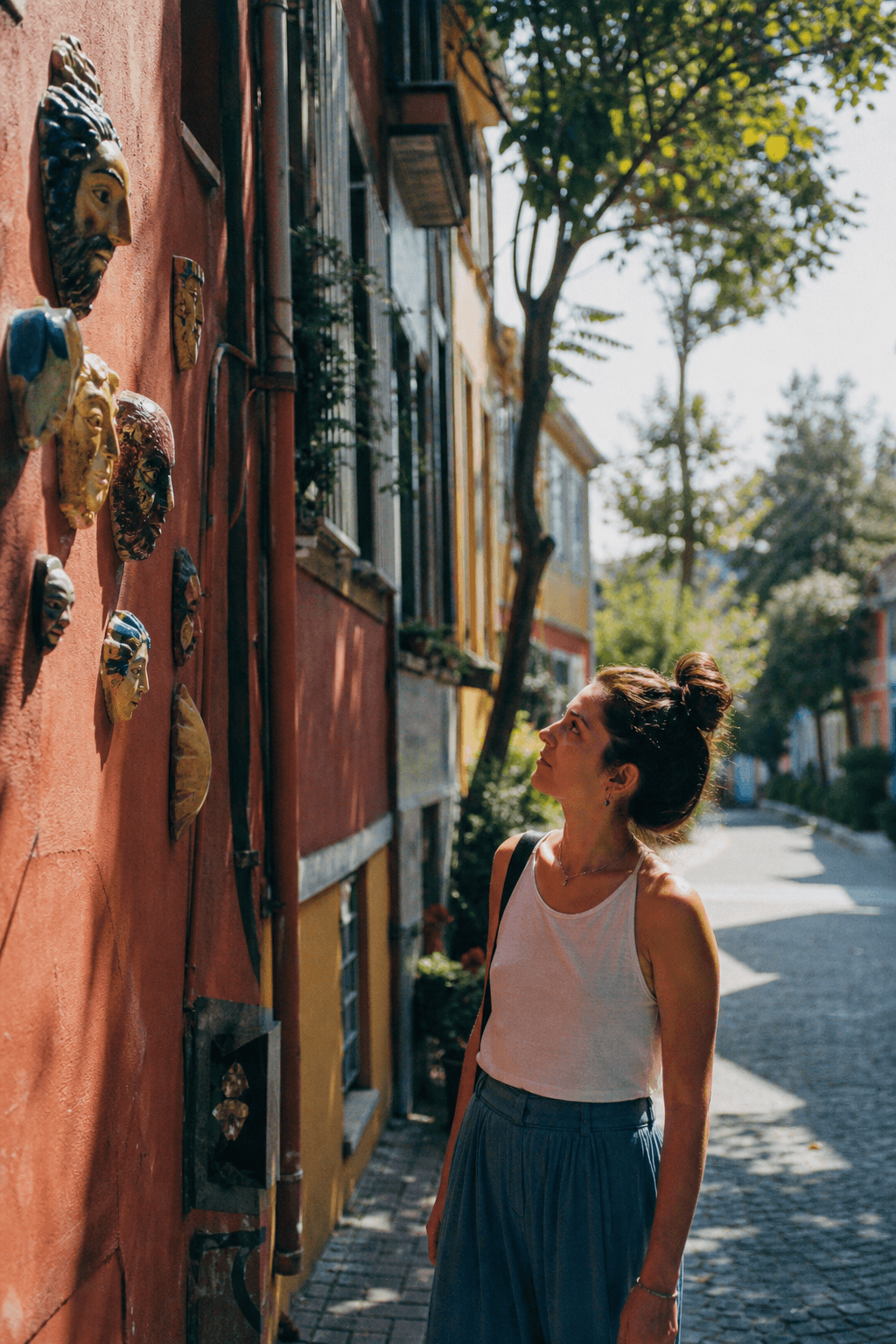 An explorer noticing a public-art detail along a neighborhood trail